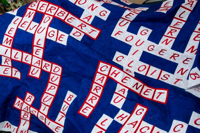 A closeup of the Nos Aïeuls (our Ancestors) quilt with some bias still needing to be attached.