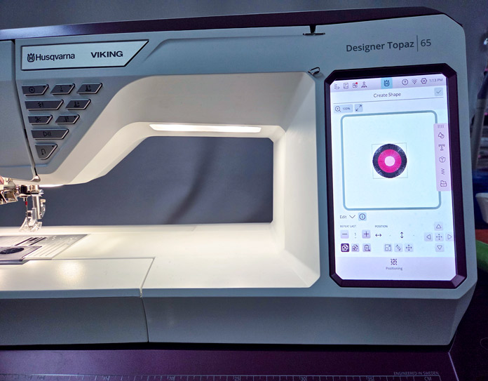 A floral motif on the screen of an embroidery machine