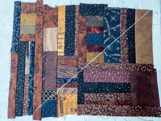 A white chalk line on brown, scrappy fabric