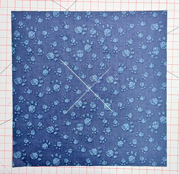 An X is drawn on the fabric.