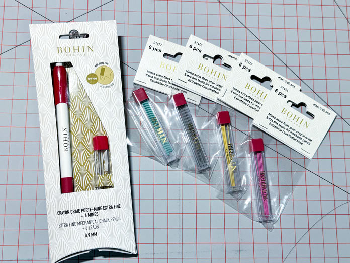 A BOHIN Mechanical pencil with additional leads in green, black, yellow and pink colors.