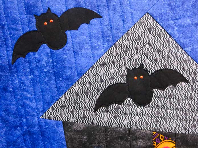 Rhinestone eyes are added to the bat shapes