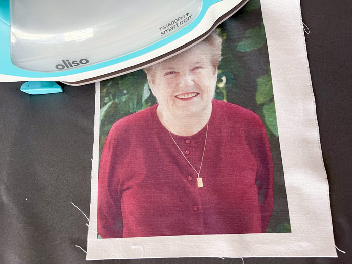 A photo of a smiling woman is pressed to set the inks; Oliso Pro TG1600 Pro Plus Smart Iron