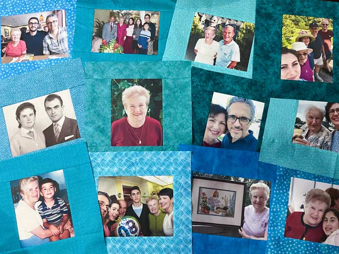 Multiple family photos printed on fabric, each framed in blue green fabrics, are laid out to view.