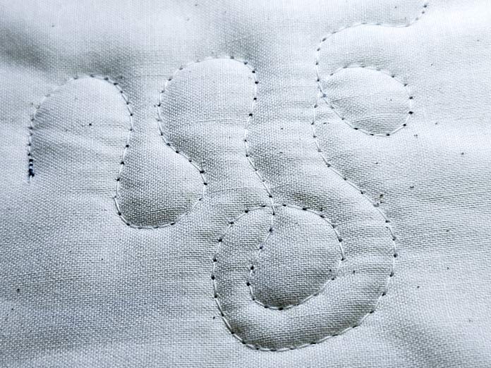 Beige quilting stitches on beige fabric