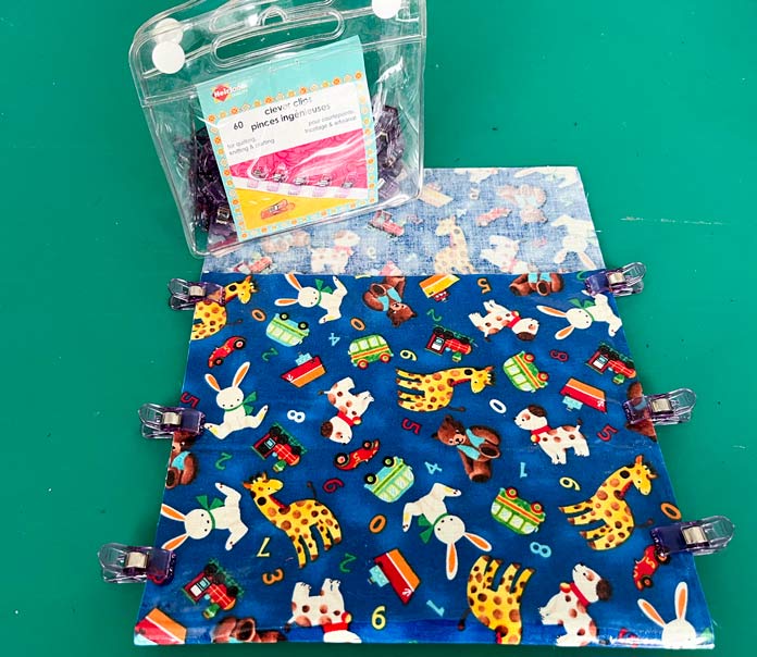 6 UNIQUE Quilting Clever Clips hold the fabric in place for sewing a blue patterned snack bag