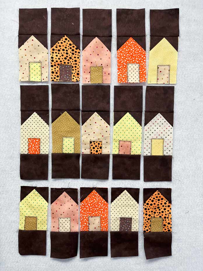 3" background squares have been sewn to each house block.