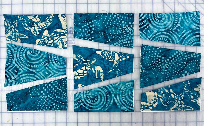 The turquoise fabrics have been arranged so there are 3 different fabrics in each rectangle.