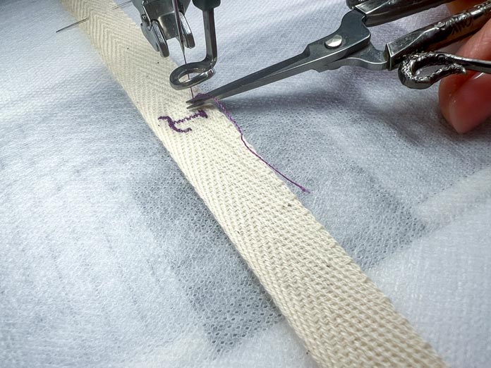 A creative 260 x 200 Elite  Hoop (260 x 200 mm)  with hooped lace and stabilizer sandwich; the cutting and removing thread tail process after each letter   