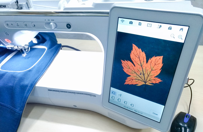 Close-up of the Brother Luminaire XP screen showing the maple leaf on fabric.