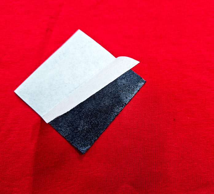 White and blue image on red fabric