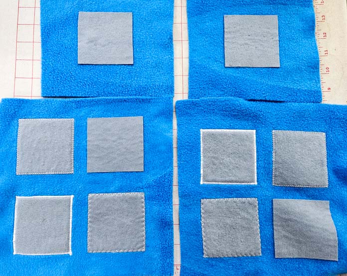 Gray squares on blue fleece; HeatnBond, fusible web, sewing, applique, quilting, hemming, fabric adhesive, SoftStretch, Lite, Featherlite, Ultra, sewing tips, crafting, fabric experiments