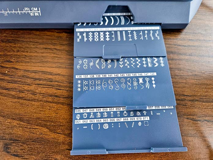 Three stitch charts on a sewing machine