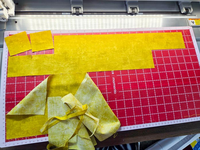 Yellow fabric on a red digital cutter mat