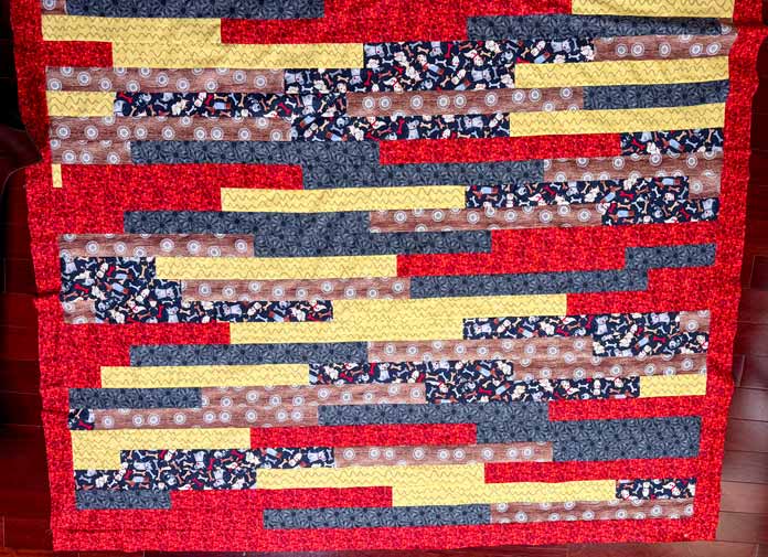 The red inner border is added to the quilt’s center.
