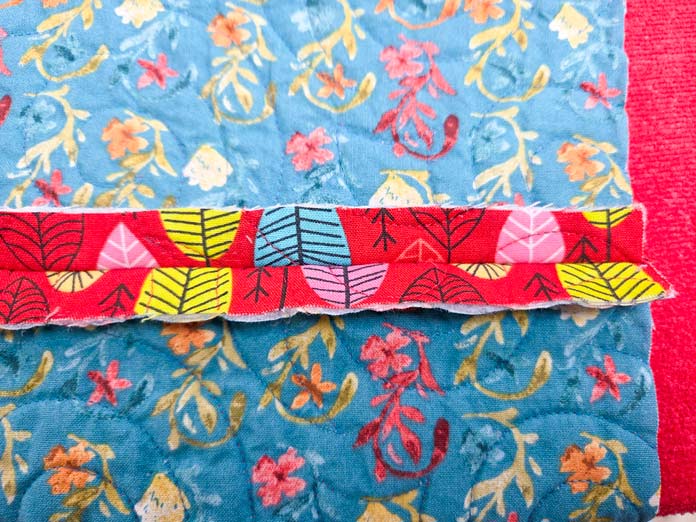 Red and blue fabric with a seam allowance pressed open