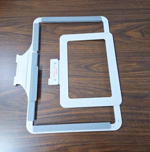 Two grey machine embroidery hoops on top of each other