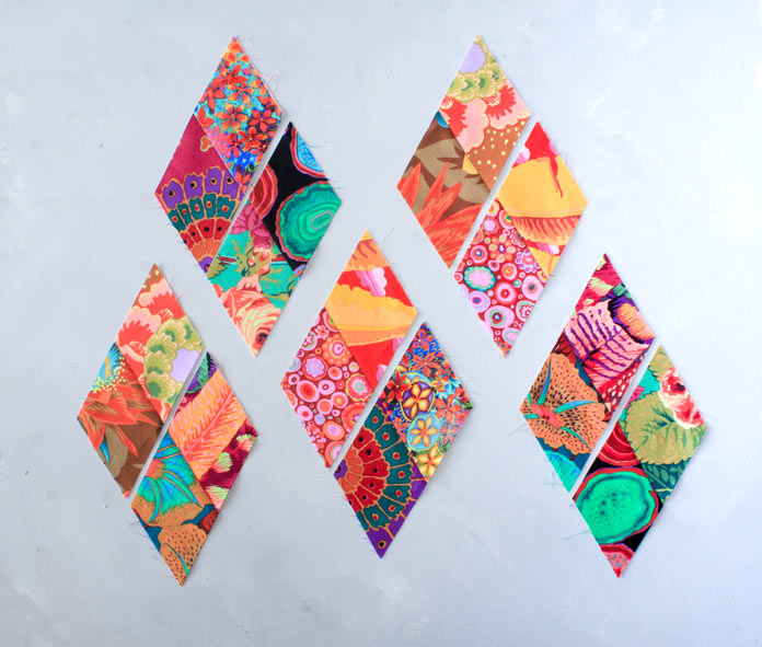 Grouping the units 2x2 to make the 4-patch diamond; 5 groups of colorful fabrics.
