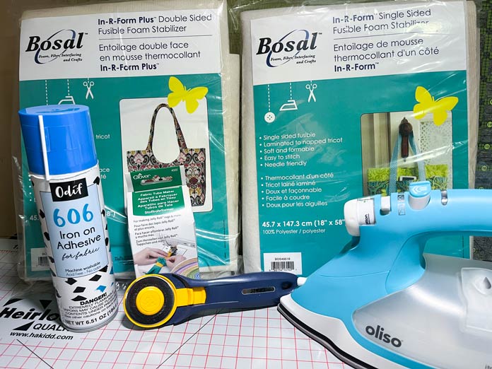 Some of the products used this week include a can of Odif 606 Iron on Adhesive for fabric, OLFA Splash Handle Rotary Cutter, Bosal In-R-Form Double Sided Fusible Foam Stabilizer, Bosal In-R-Form Single Sided Fusible Foam Stabilizer, Clover Fabric Tube Maker, an Oliso Pro TG1600 Pro Plus Smart Iron, and an Heirloom Double Sided Cutting Mat