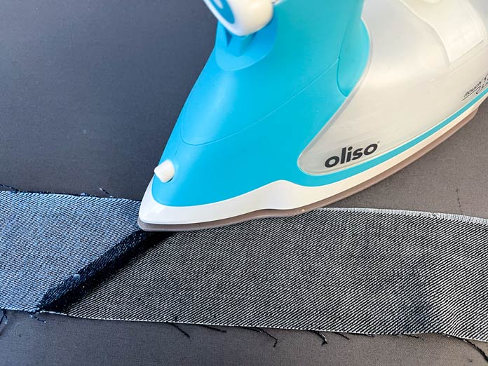 Using an Oliso TG1600 Pro Plus Smart Iron, a seam is pressed open.
