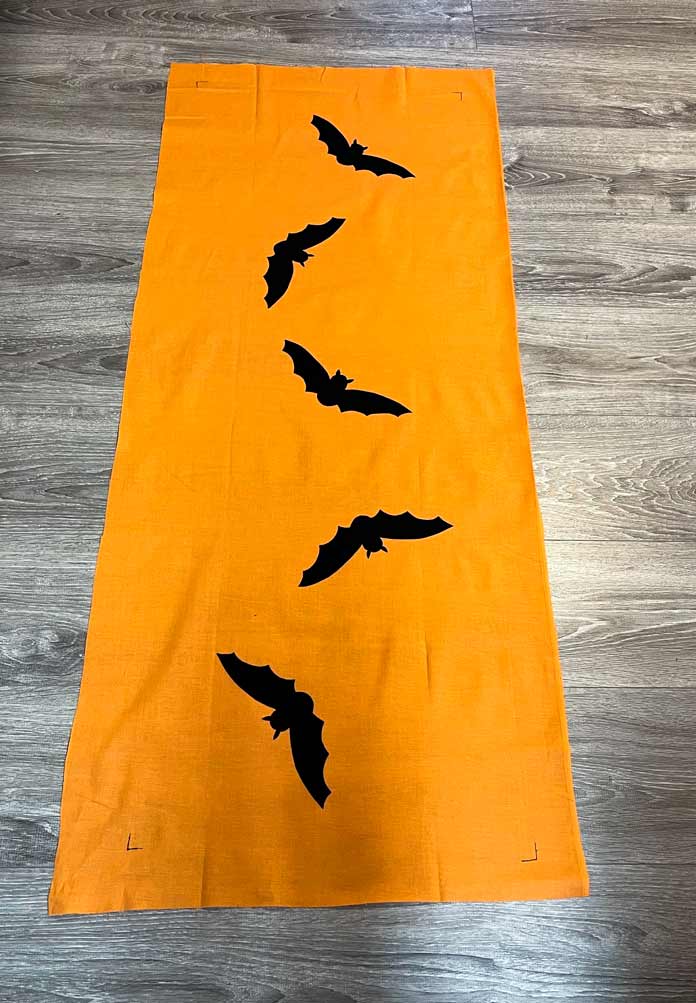 5 bats pressed onto the orange backing fabric for the table runner