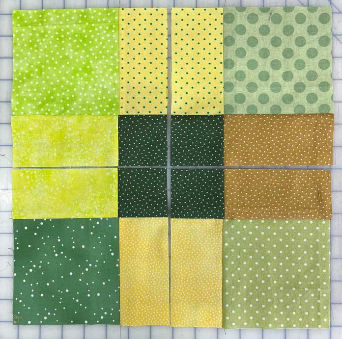 A Nine-Patch block made with 5" squares is cut in half from top to bottom and side to side.