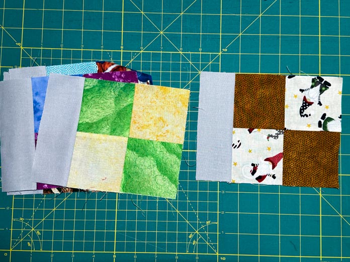 Grey rectangles have been sewn to a variety of four patches.