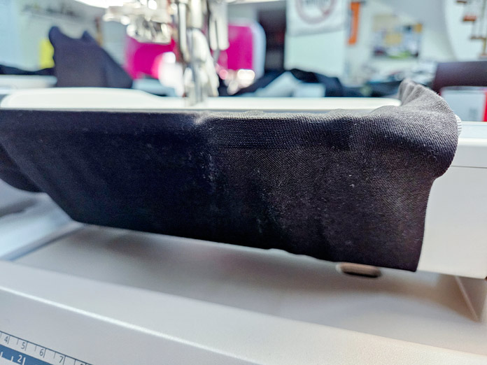 A black pant leg around a free arm on an embroidery machine; Husqvarna VIKING DESIGNER EPIC 3