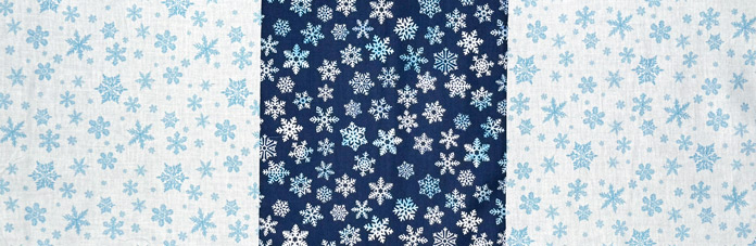 The center row of the quilt top made from a white, dark blue and another white snowflake fabrics.