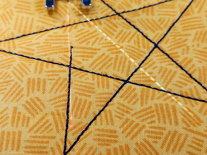 Blue lines and one white line on yellow fabric