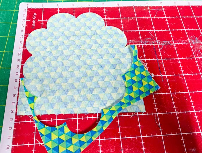 Yellow, blue, and green fabric on a red mat