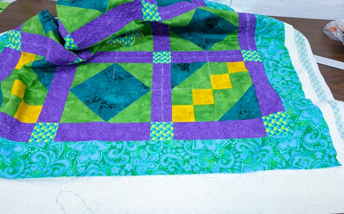 A brightly colored quilt on a table; Creativate Embroidery Software