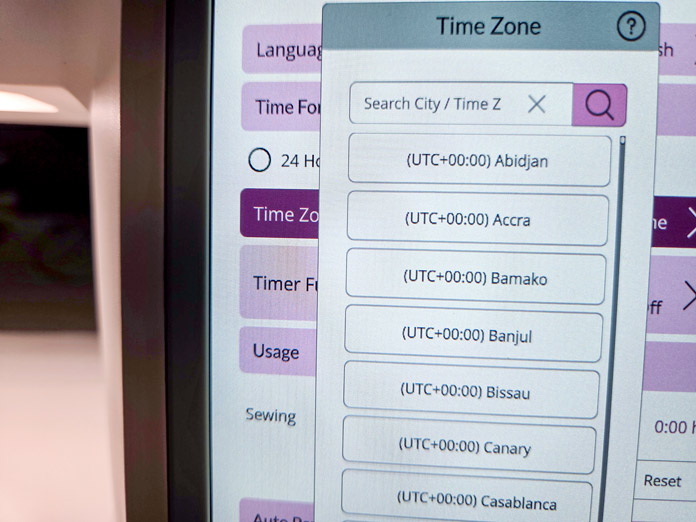 A list of time zones on a computerized sewing machine screen