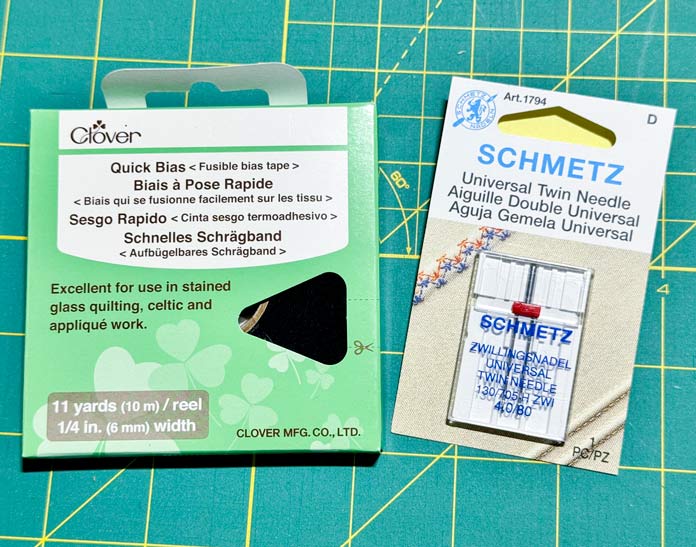 A package of CLOVER 700/1128 - Quick Bias Tape and a SCHMETZ Twin Needle 