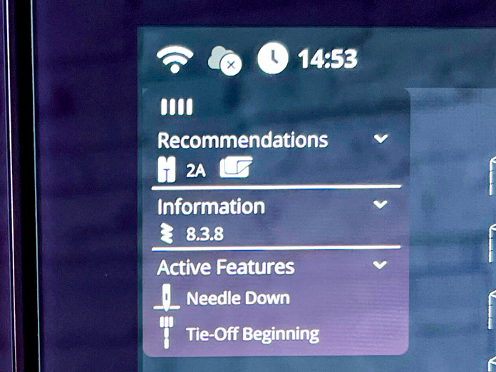 The display shows the active foot recommendation (2A without IDT), selected stitch 8.3.8, and active features including "Needle Down" and "Tie-Off Beginning". 