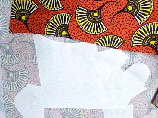 A sheet of white paper on orange fabric