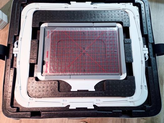 Two machine embroidery hoops in a black case