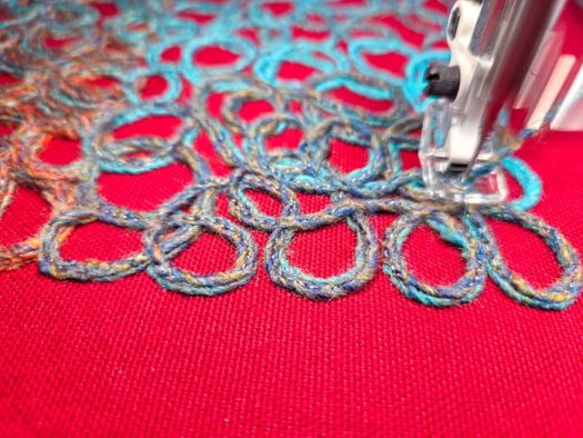 Multi-colored yarn on red fabric