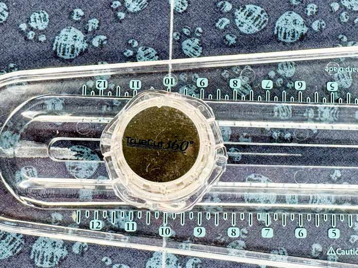 An X is drawn on the fabric.