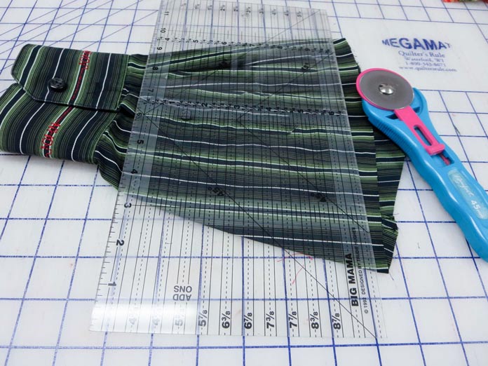 A rotary cutter and ruler are used to trim the cut edge of the sleeve; Brother NQ700, Brother BQ3050, HeatnBond Feather Lite, Brother SA185 ¼" Piecing Foot-Guide, Brother SA125 ¼" Quilting Foot, Brother SA186 Metal Open-Toe Foot, SULKY Heidi Lund's Life in the Tropics Cotton Blendables Thread Collection