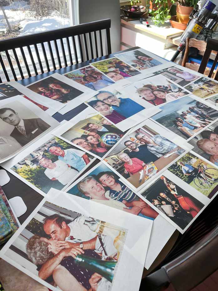 Multiple family photos printed on fabric placed to view on a table.