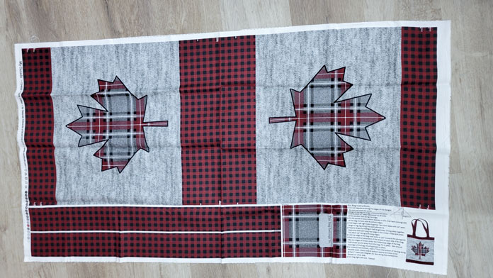 A red and black checked and gray fabric with a maple leaf