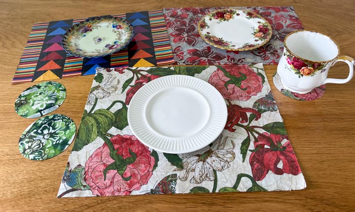 Plates sitting on 3 different placemats and a mug on a coaster
