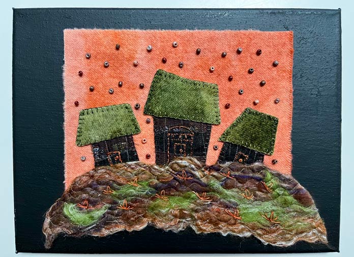 Appliqued scene is attached to a black artist's canvas with fusible web; Solvy Water Soluble Stabilizers