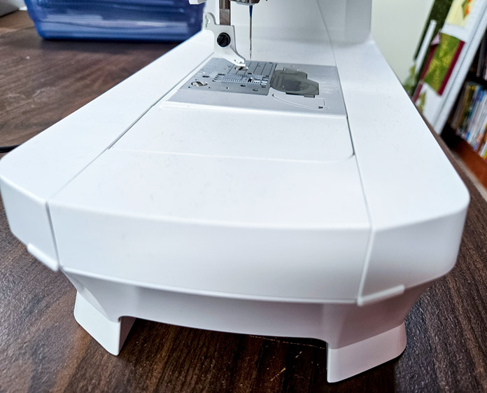 A white accessory tray on a sewing machine; Husqvarna VIKING Designer Quartz 29, mySewnet Machine Embroidery Software 