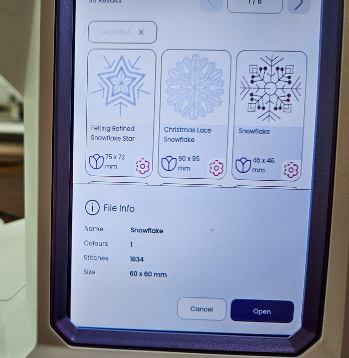 A screen on a computerized sewing and embroidery machine shows information about a selected snowflake design; Husqvarna VIKING Designer Quartz 29, mySewnet Machine Embroidery Software, mySewnet Library, Husqvarna VIKING Tear-a-Way Light Stabilizer 15 Inches x 25 Yards