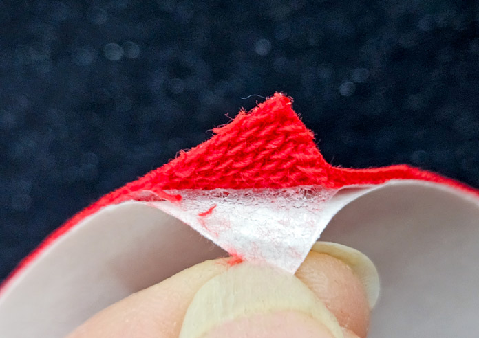 A red and white corner of fabric; Learn how to use HeatnBond SOFTSTRETCH fusible web on knits, denim, fleece, and more