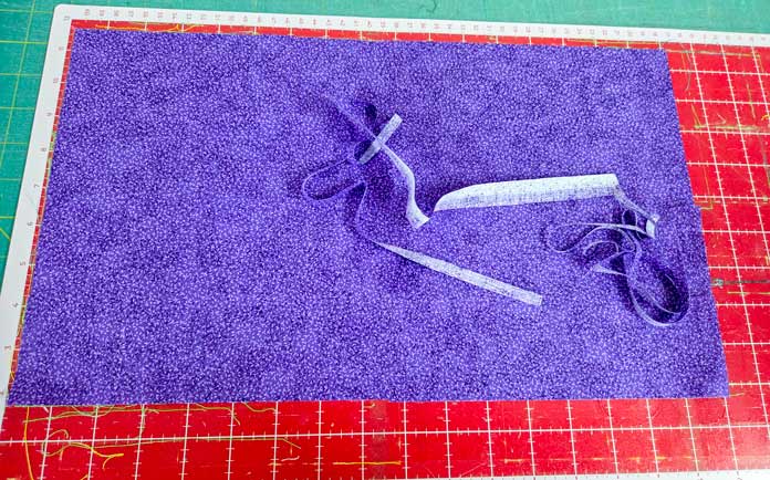 Purple fabric on a red digital cutting mat