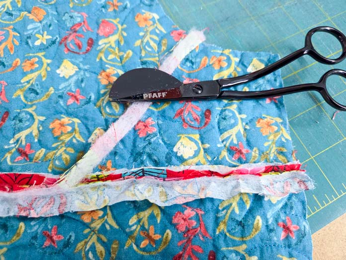 Black scissors on blue fabric
