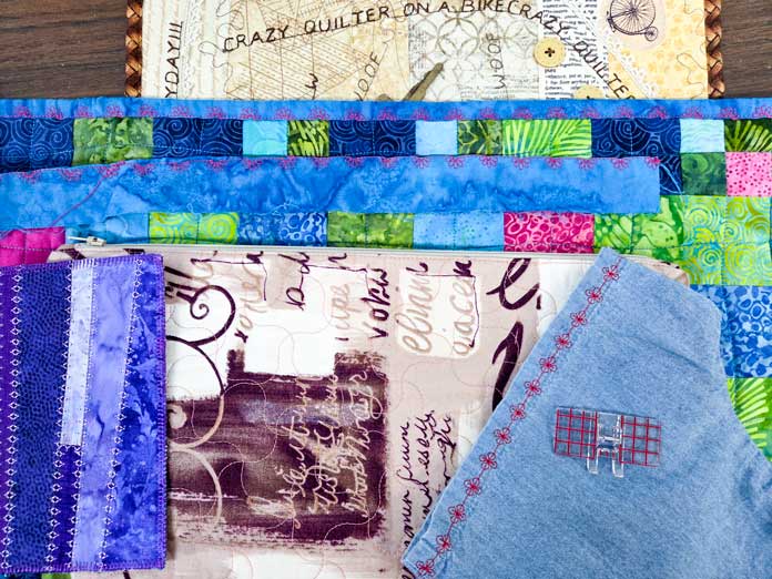 A variety of brightly colored fabrics with decorative stitches